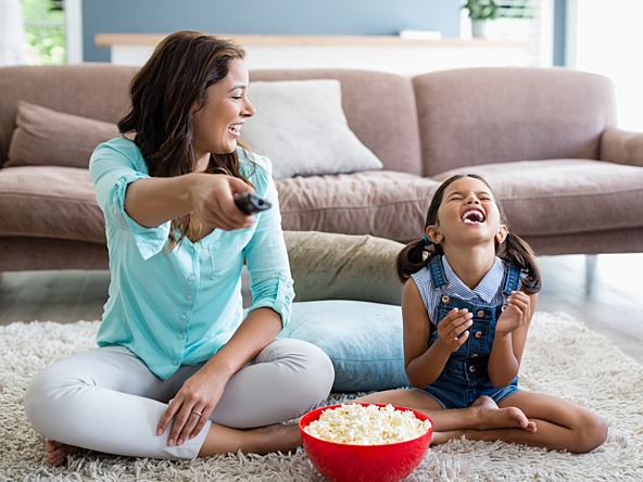 Mother and daughter watching tv_crop